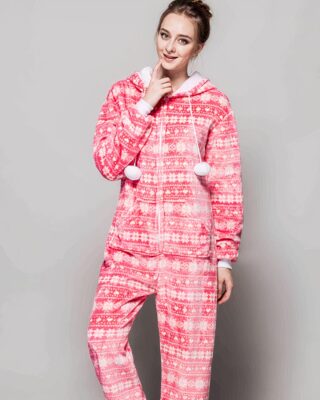 Pink fleece Christmas suit with a grey background and a girl wearing the suit