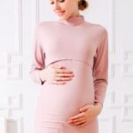 Pink cotton two-piece maternity pajamas worn by a pregnant blonde woman