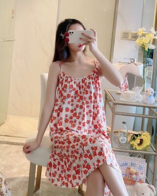 Pajamas cotton nightgown with red flower pattern worn by a woman in a house sitting on a chair in a house