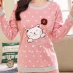Cute pink and gray cat hot pajamas with a woman wearing the pajamas