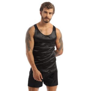 Dark-haired and tattooed man wearing black satin pajamas with a black tank top and matching black shorts