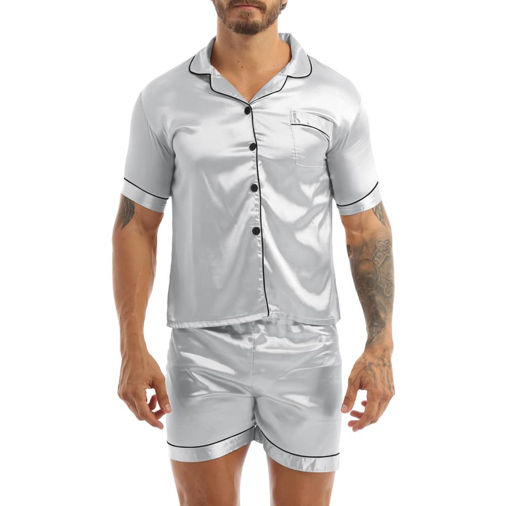 Gray satin pajamas worn by a man tattooed on his left arm, the pajamas are composed of shorts and a shirt with buttons on the front