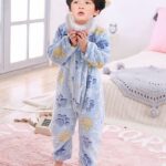 Blue boys animal suits with a child wearing the suit in the background of a child's room