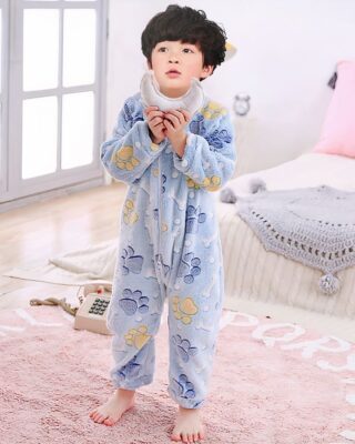 Blue boys animal suits with a child wearing the suit in the background of a child's room