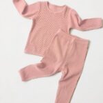 Two-piece pyjamas in pink cotton with white background