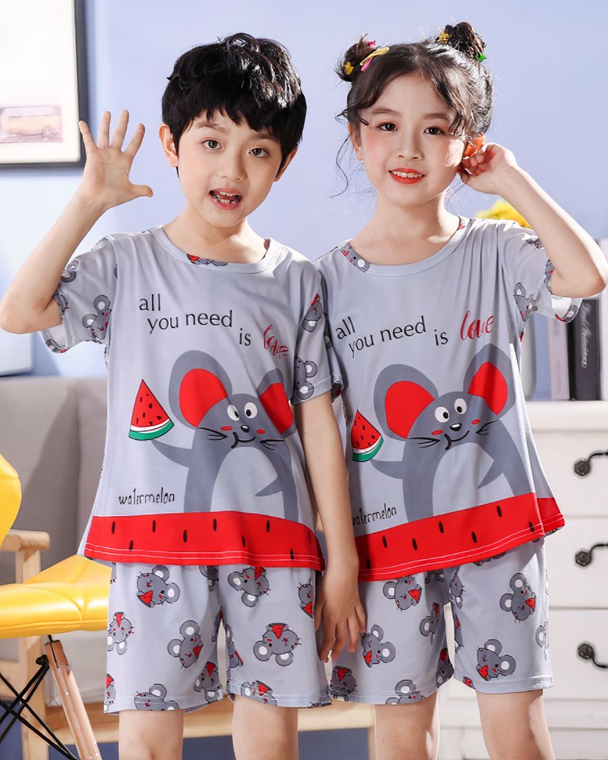 Grey short sleeve summer pajamas with mouse pattern for children worn by a little girl and a little boy in a house