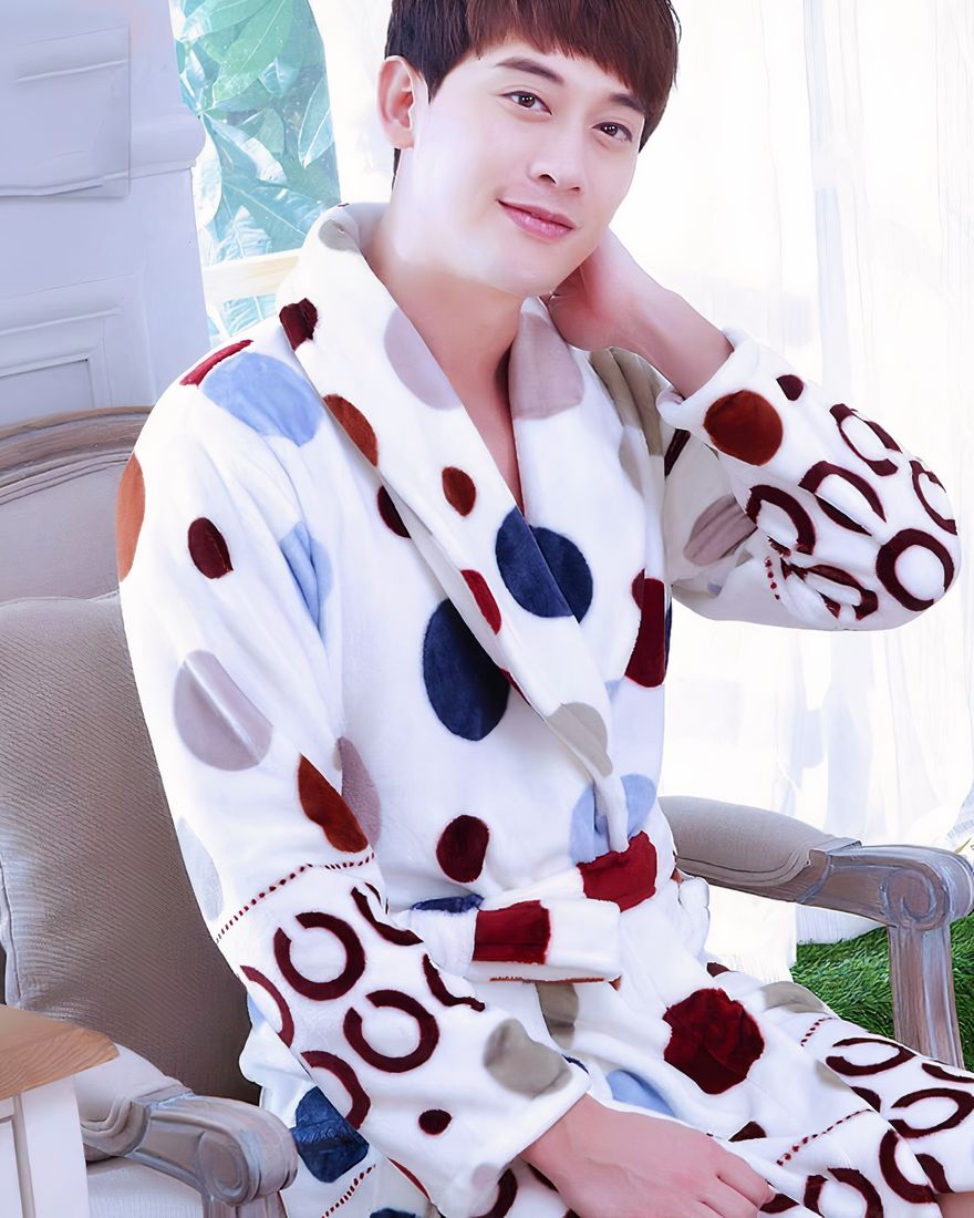 Pyjamas flannel bathrobe with multicolored polka dot pattern for men worn by a man sitting on a chair in a house