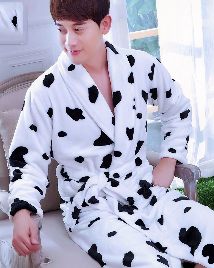Flannel kimono pajamas with cow print for men fashionable worn by a man sitting on a chair
