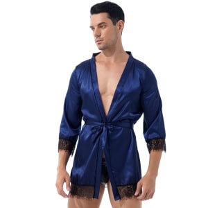 brown man wearing a navy blue short satin kimono pajamas with black lace trim and V-neck