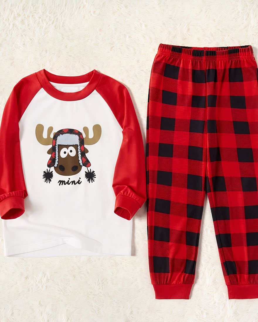 White and red Christmas pyjamas for children and babies with a beige background