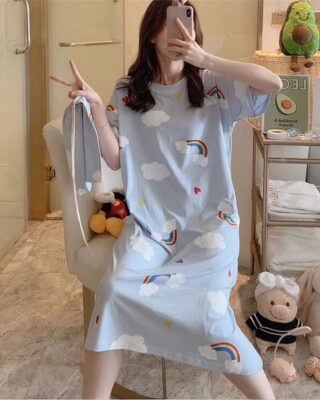 Fashionable short-sleeved nightgown with cloud and rainbow pattern worn by a woman sitting on a chair in a house