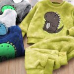 Pyjamas dino very soft in several colors in a wooden background