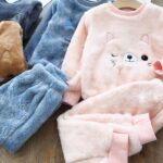 Pajamas with a soft cat pattern, in two colors, blue and pink, and in two pieces, a pair of pants and a warm top