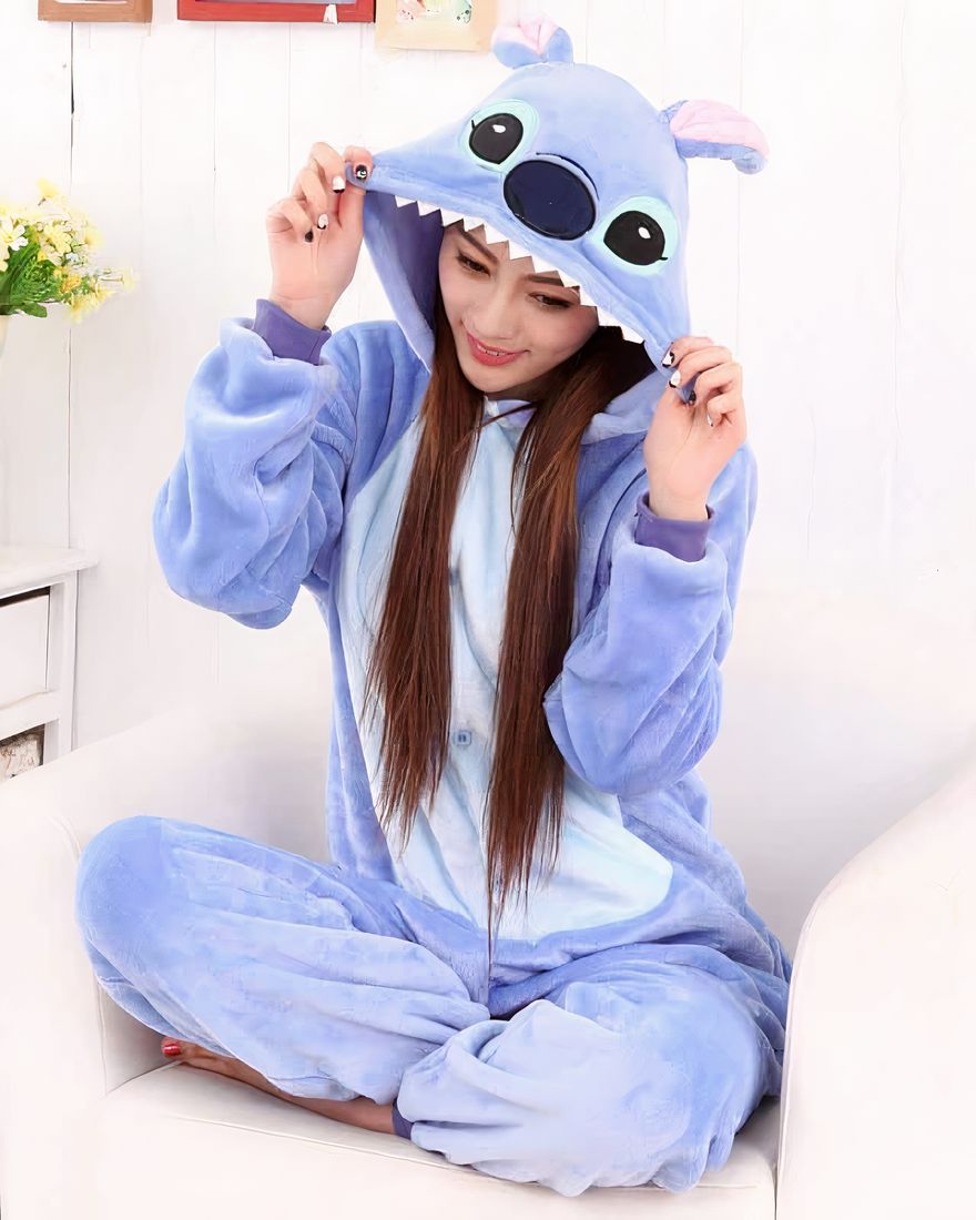 Stich one-piece fleece pajamas. The front of the belly is in light blue color while the rest is in darker blue. On the hood there are the eyes, the nose and the ears of Stich and on the edge of the hood there are the teeth.