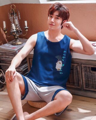 Blue sleeveless t-shirt and gray shorts for men sitting on a carpet