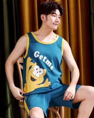 Dark green sleeveless cotton pajamas with cat print worn by a man sitting on a chair