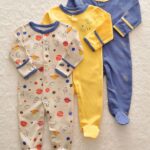 3-piece space and astronaut pajama suit for baby with beige background