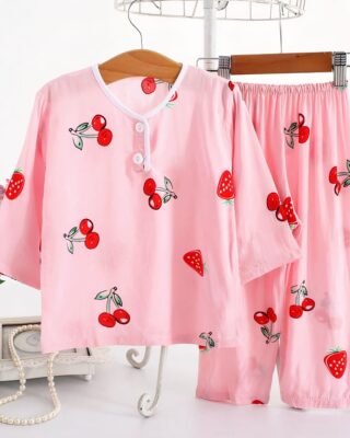 Cotton pajamas with half-length sleeves strawberry and pink cherry pattern on a belt in a house