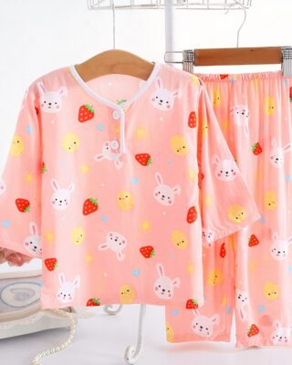 Two-piece cotton pajamas with strawberry and rabbit design for pink child on a belt in a house