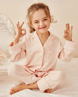 Two pieces lace pajamas for "do like Mom" with a little girl wearing the pajamas with a white crib and a pink background