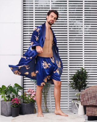 Two-piece satin kimono pajamas with dragon print worn by a fashionable man