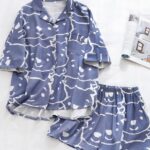 Two piece short sleeve summer pajamas with cartoon print and magazine on the side