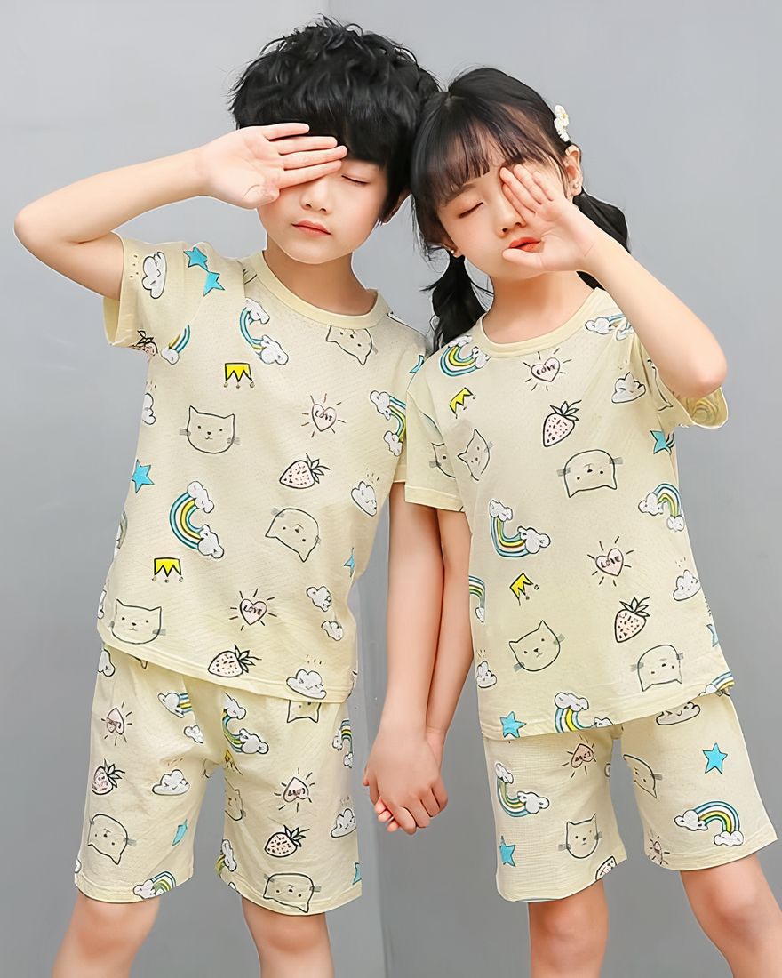 White two-piece pajamas with cartoon pattern for children with two children wearing the pajamas and a gray background
