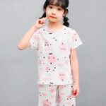 White two-piece pajamas with cartoon print for little girl with a girl wearing the pajamas