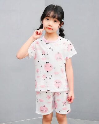 White two-piece pajamas with cartoon print for little girl with a girl wearing the pajamas