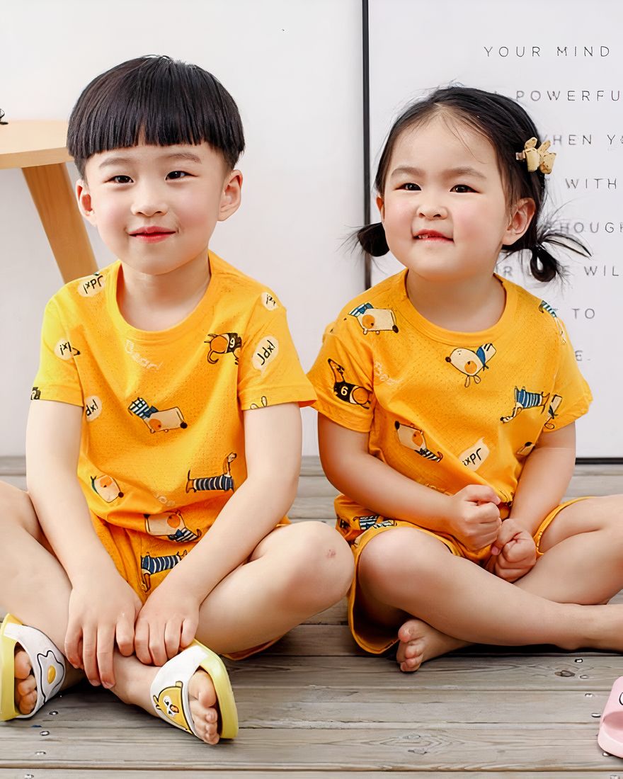 Yellow two-piece pajamas with cartoon pattern for children with two small children wearing the pajamas