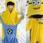 Minions pajama suit for child with a little one wearing the pajamas with a white bed background