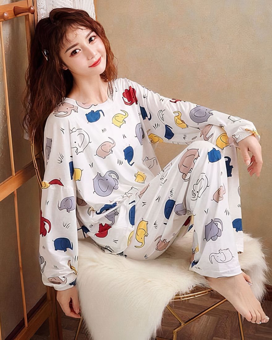 Long-sleeved fall pajamas with elephant print worn by a woman sitting on a chair