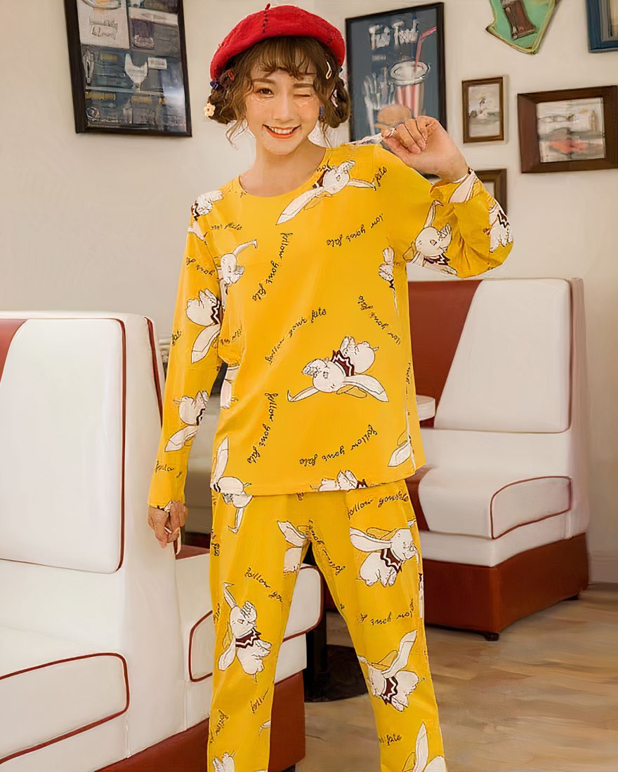 Long sleeve pajamas with Dumbo print for women worn by a woman in a house