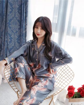 Long sleeve spring pajamas with bird print worn by a woman sitting on a chair in a house