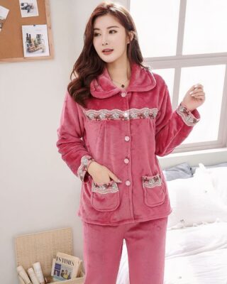 Women's warm fleece pajama set worn by a woman in a house