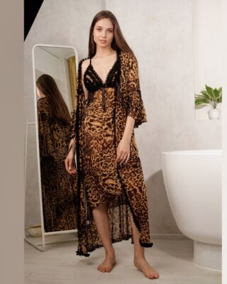 Sexy leopard print pajamas worn by a woman in a bathroom with white walls and floor next to a white bathtub with a small plant and in front of a mirror