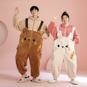 Pajama suit with hood in brown and beige worn by a woman and a man in a pink room