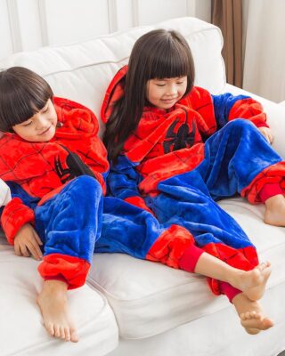 Two children on sofa with blue and red spiderman pajama set