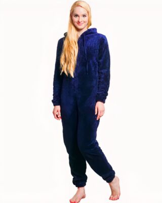 Young blonde woman wearing a pyjama in a dark blue suit and presented on a white background